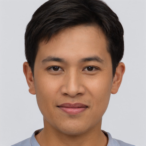 Joyful asian young-adult male with short  black hair and brown eyes