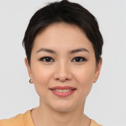 Joyful asian young-adult female with short  brown hair and brown eyes