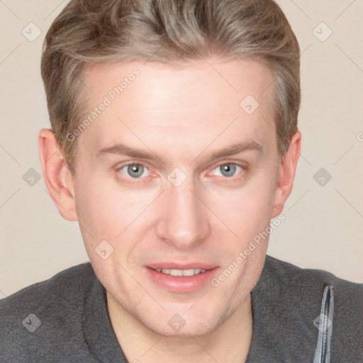 Joyful white adult male with short  brown hair and blue eyes