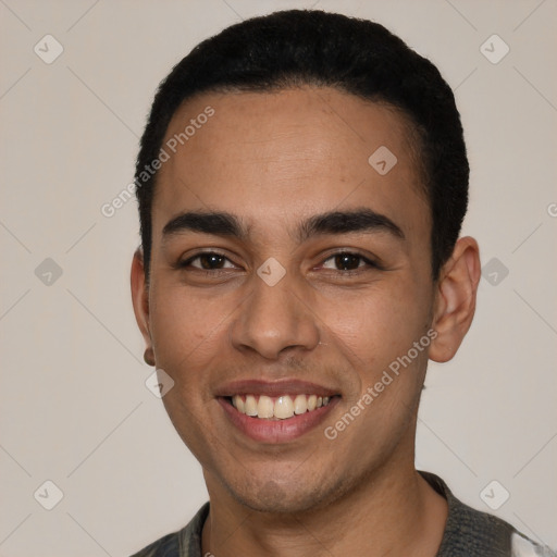 Joyful latino young-adult male with short  black hair and brown eyes