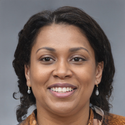 Joyful black adult female with medium  brown hair and brown eyes