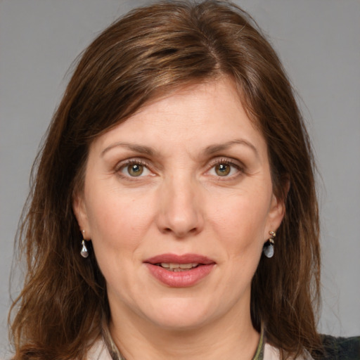 Joyful white adult female with medium  brown hair and grey eyes