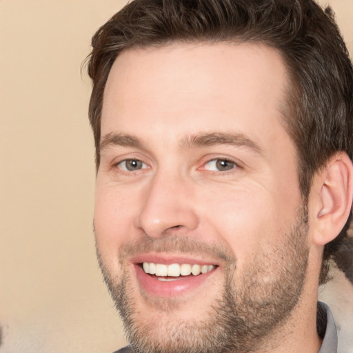 Joyful white adult male with short  brown hair and brown eyes