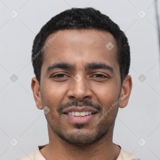 Joyful latino young-adult male with short  black hair and brown eyes