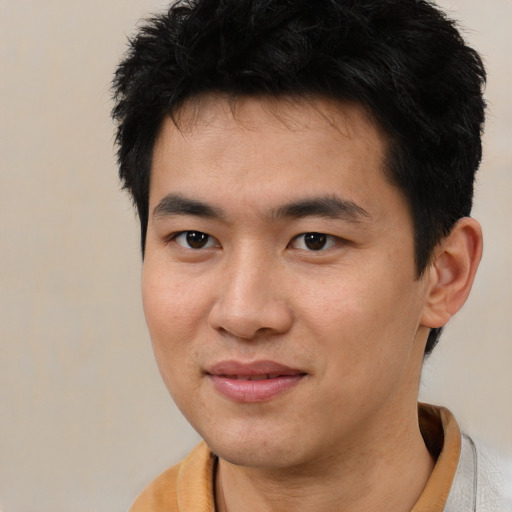 Joyful asian young-adult male with short  brown hair and brown eyes