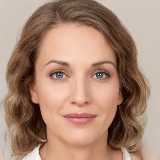 Joyful white young-adult female with medium  brown hair and green eyes