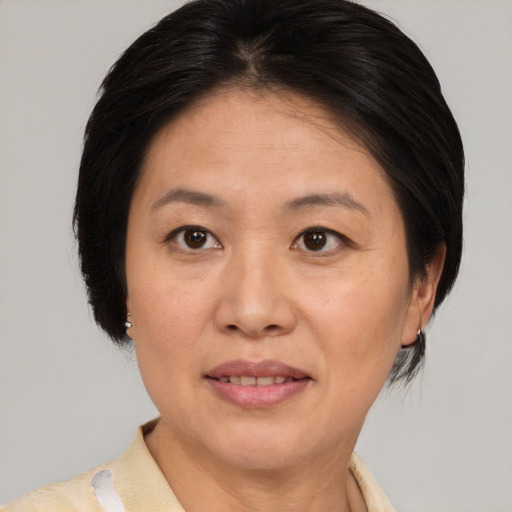 Joyful white adult female with medium  brown hair and brown eyes