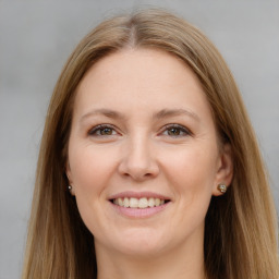 Joyful white young-adult female with long  brown hair and grey eyes