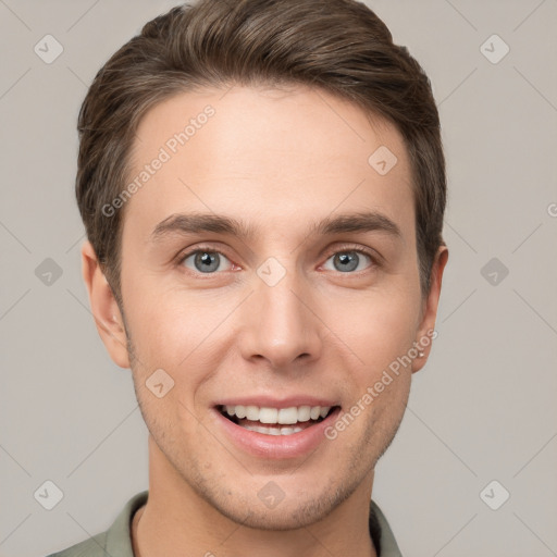 Joyful white young-adult male with short  brown hair and grey eyes