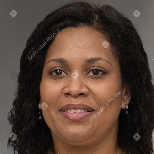 Joyful black adult female with long  brown hair and brown eyes