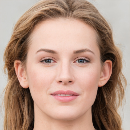 Joyful white young-adult female with long  brown hair and blue eyes