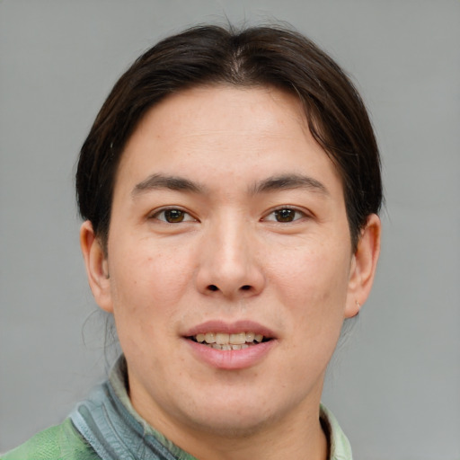 Joyful asian young-adult male with short  brown hair and brown eyes