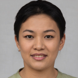 Joyful asian young-adult female with short  black hair and brown eyes