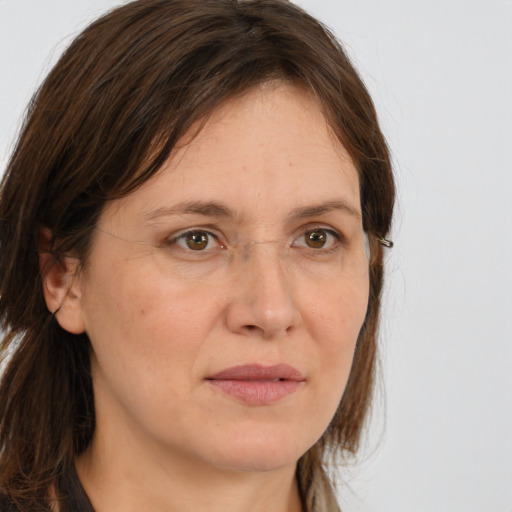 Joyful white adult female with long  brown hair and brown eyes