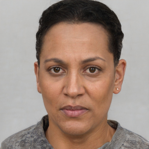 Joyful white adult female with short  black hair and brown eyes