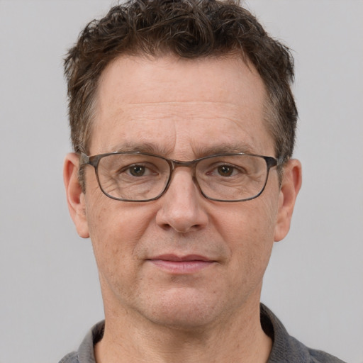 Joyful white middle-aged male with short  brown hair and grey eyes