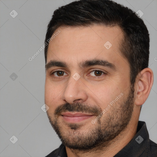 Joyful white young-adult male with short  black hair and brown eyes