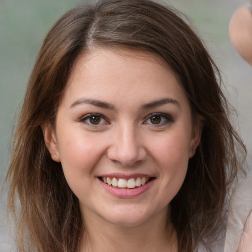 Joyful white young-adult female with medium  brown hair and brown eyes