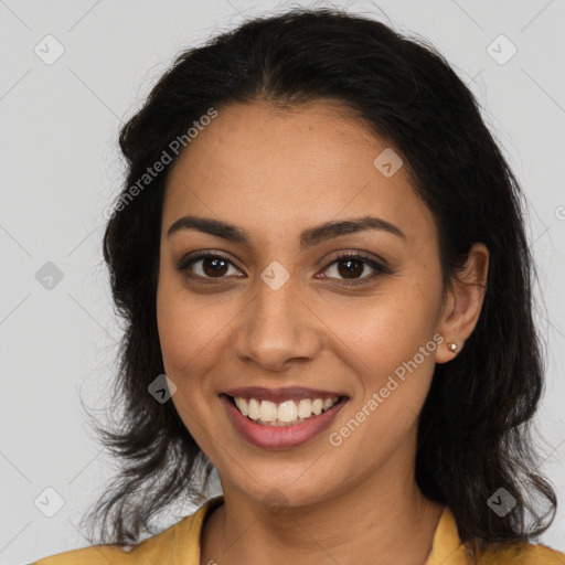 Joyful latino young-adult female with long  brown hair and brown eyes