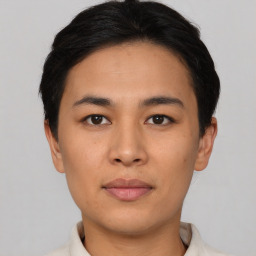 Joyful asian young-adult male with short  black hair and brown eyes