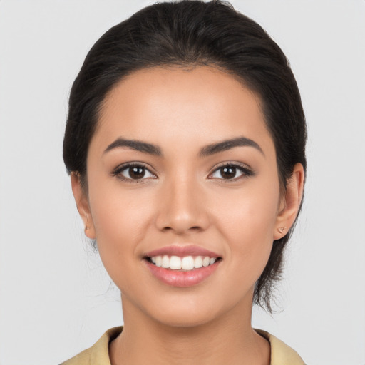 Joyful latino young-adult female with medium  black hair and brown eyes