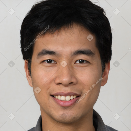 Joyful asian young-adult male with short  black hair and brown eyes