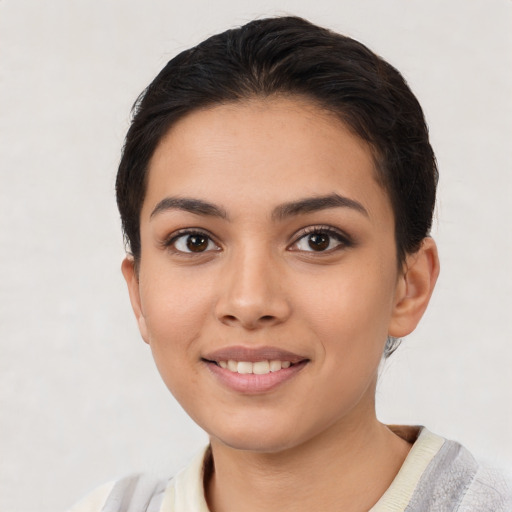Joyful latino young-adult female with short  brown hair and brown eyes