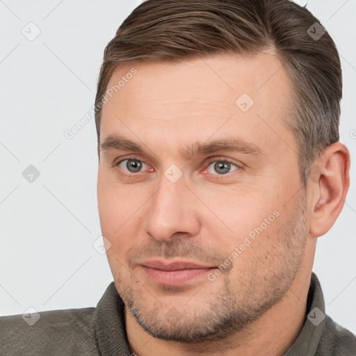 Joyful white adult male with short  brown hair and brown eyes