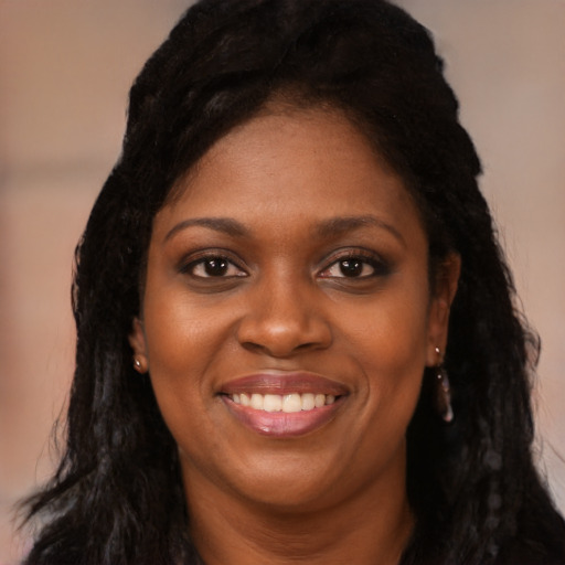Joyful black young-adult female with long  black hair and brown eyes