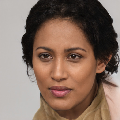 Joyful black young-adult female with long  brown hair and brown eyes