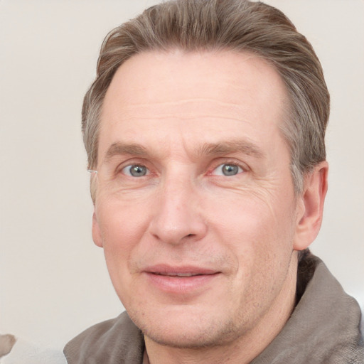 Joyful white adult male with short  brown hair and grey eyes