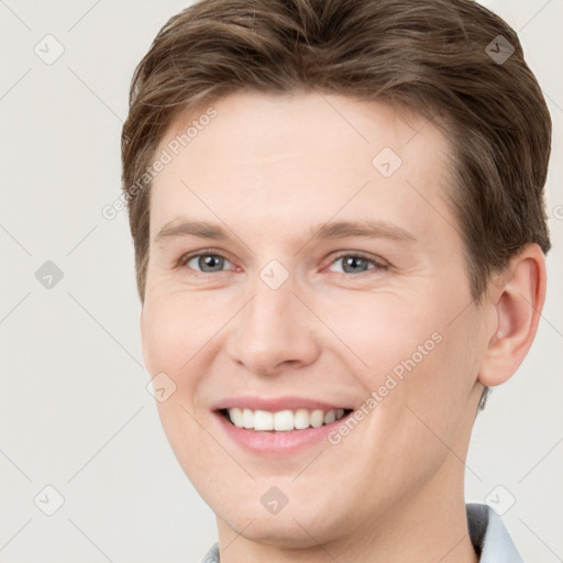 Joyful white young-adult female with short  brown hair and grey eyes