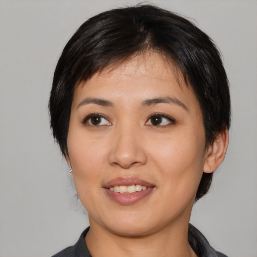 Joyful asian young-adult female with medium  black hair and brown eyes