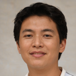 Joyful asian young-adult male with short  brown hair and brown eyes