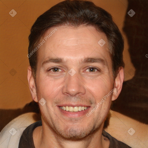 Joyful white adult male with short  brown hair and brown eyes