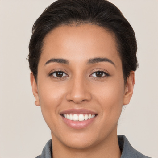 Joyful white young-adult female with short  brown hair and brown eyes