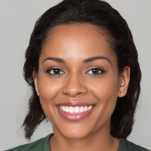 Joyful latino young-adult female with medium  brown hair and brown eyes