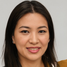 Joyful asian young-adult female with long  brown hair and brown eyes