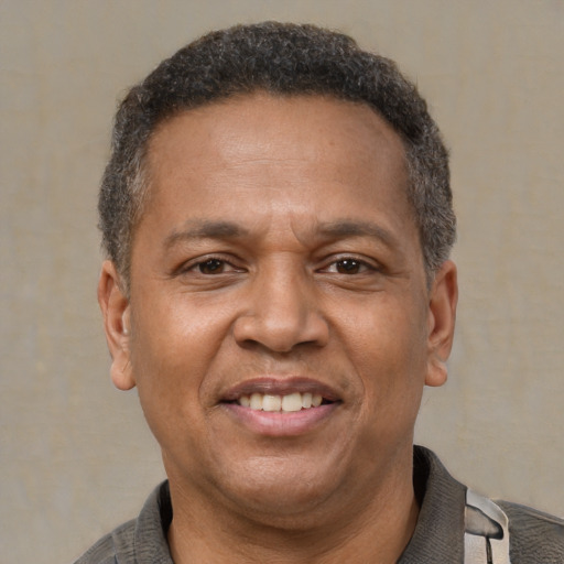 Joyful latino adult male with short  brown hair and brown eyes