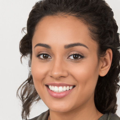 Joyful latino young-adult female with long  brown hair and brown eyes