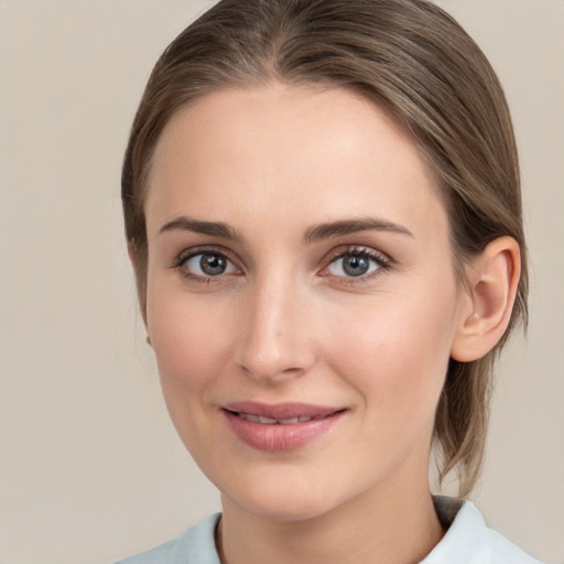 Joyful white young-adult female with medium  brown hair and grey eyes