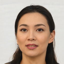 Joyful asian young-adult female with long  brown hair and brown eyes