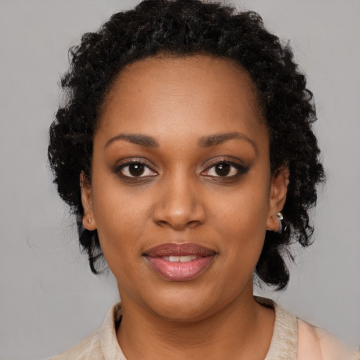 Joyful black young-adult female with medium  brown hair and brown eyes