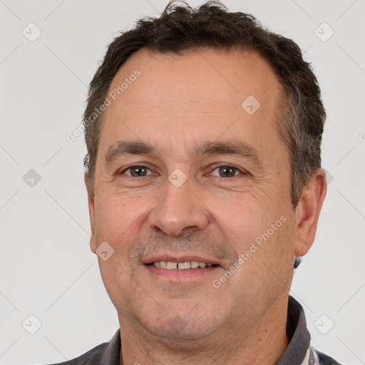 Joyful white adult male with short  brown hair and brown eyes