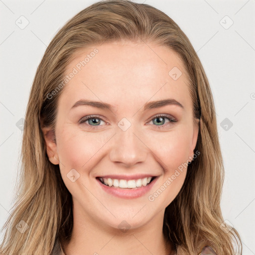 Joyful white young-adult female with long  brown hair and blue eyes