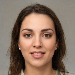 Joyful white young-adult female with medium  brown hair and green eyes