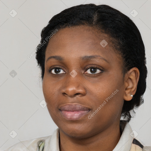 Joyful black young-adult female with short  black hair and brown eyes