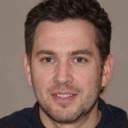 Joyful white adult male with short  brown hair and brown eyes