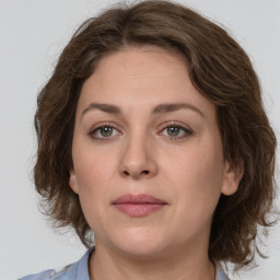 Joyful white young-adult female with medium  brown hair and green eyes