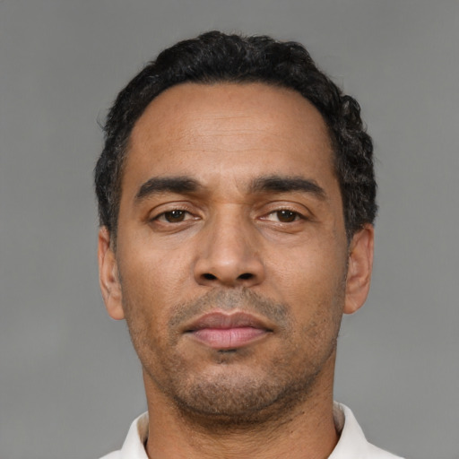 Neutral latino adult male with short  black hair and brown eyes